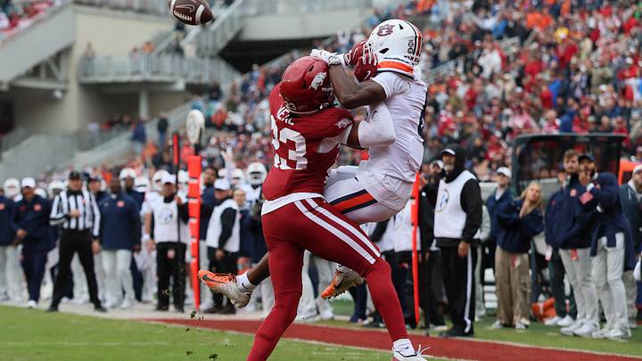 Auburn Tigers wide receiver Cam Coleman (8) receives a pass for a touchdown as Arkansas Razorbacks defensive back Julian Neal (23) defends.