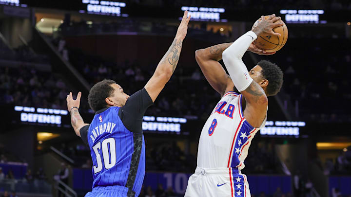 Philadelphia 76ers forward Paul George (8) shoots over Orlando Magic guard Cole Anthony (50) during the first quarter at Kia Center.