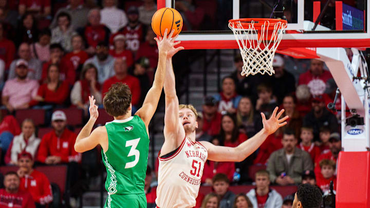 Nebraska forward Rienk Mast blocks a shot from North Dakota guard Greyson Uelmen.