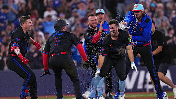 Toronto Blue Jays third baseman Ernie Clement (22) celebrates the win with outfielder Myles Straw (3) against the Los Angeles Angels.