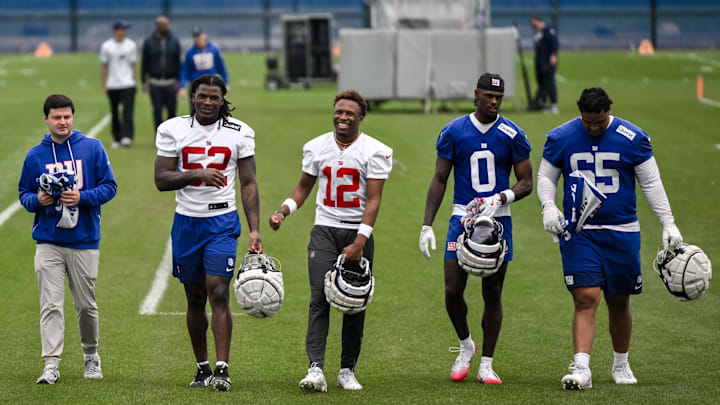 May 9, 2026; East Rutherford, NJ, USA; New York Giants rookies Arvell Reese (52), Colton Hood (12), Malachi Fields (0) and Francis Mauigoa (65) walk off the field after rookie minicamp at Quest Diagnostics Training Center. 