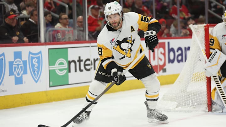 Apr 6, 2025; Chicago, Illinois, USA; Pittsburgh Penguins defenseman Kris Letang (58) skates with the puck against the Pittsburgh Penguins during the third period at United Center. Mandatory Credit: Talia Sprague-Imagn Images