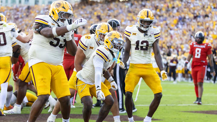 Oct 18, 2025; Tempe, Arizona, USA; Arizona State Sun Devils running back Raleek Brown (3) celebrates with offensive lineman Josh Atkins (53) and wide receiver Malik McClain (12) after scoring a touchdown against the Texas Tech Red Raiders in the fourth quarter at Mountain America Stadium. Mandatory Credit: Mark J. Rebilas-Imagn Images Oct 18, 2025; Tempe, Arizona, USA; Arizona State Sun Devils running back Raleek Brown (3) celebrates with offensive lineman Josh Atkins (53) and wide receiver Malik McClain (12) after scoring a touchdown against the Texas Tech Red Raiders in the fourth quarter at Mountain America Stadium. Mandatory Credit: Mark J. Rebilas-Imagn Images