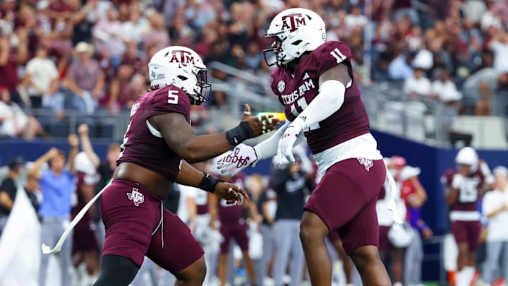 Sep 28, 2024; Arlington, Texas, USA;  Texas A&M Aggies defensive lineman Nic Scourton (11) celebrates with Texas A&M Aggies defensive lineman Shemar Turner (5) during the first half against the Arkansas Razorbacks at AT&T Stadium. Mandatory Credit: Kevin Jairaj-Imagn Images
