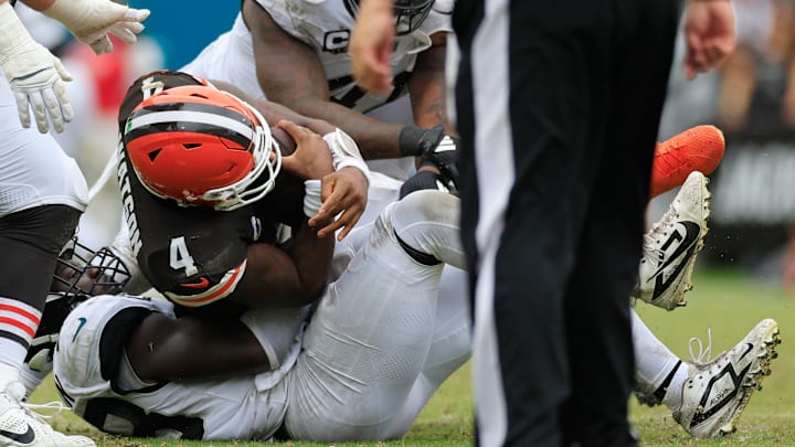Cleveland Browns quarterback Deshaun Watson (4) is sacked by Jacksonville Jaguars linebacker Foyesade Oluokun (23) during the third quarter of an NFL football matchup Sunday, Sept. 15, 2024 at EverBank Stadium in Jacksonville, Fla. The Browns defeated the Jaguars 18-13. [Corey Perrine/Florida Times-Union]