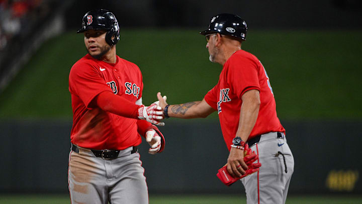 Apr 11, 2026; St. Louis, Missouri, USA; Boston Red Sox first baseman Willson Contreras (40) celebrates with first base coach José David Flores (58) after hitting a one run single against the St. Louis Cardinals during the ninth inning at Busch Stadium. Mandatory Credit: Jeff Curry-Imagn Images