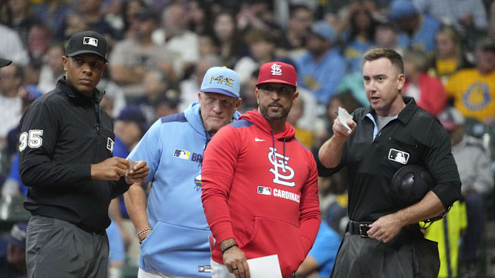 Sep 12, 2025; Milwaukee, Wisconsin, USA; Milwaukee Brewers manager Pat Murphy (49) and St. Louis Cardinals manager Oliver Marmol (37) go over the parameters of the playing field with home plate umpire Hanahan before their game at American Family Field. Also pictured is third base umpire Jeramie Rehak. Mandatory Credit: Michael McLoone-Imagn Images