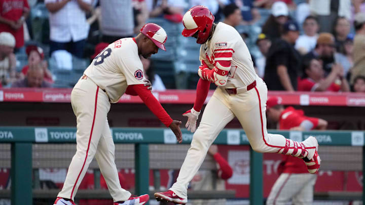 May 8, 2025; Anaheim, California, USA; Los Angeles Angels right fielder Jo Adell (7) is congratulated by third base coach Bo Porter (88) after hitting a home run in the second inning against the Toronto Blue Jays at Angel Stadium. Mandatory Credit: Kirby Lee-Imagn Images