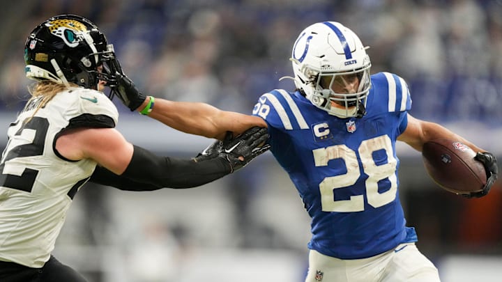 Indianapolis Colts running back Jonathan Taylor (28) pushes off Jacksonville Jaguars cornerback De'Antre Prince (24) as he rushes the ball Sunday, Jan. 5, 2025, during a game against the Jacksonville Jaguars at Lucas Oil Stadium in Indianapolis.