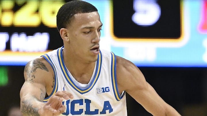 Nov 11, 2024; Los Angeles, California, USA; Boston University Terriers guard Azmar Abdullah (7) brings the ball up the court against UCLA Bruins guard Kobe Johnson (0) during the first half at Pauley Pavilion presented by Wescom. Mandatory Credit: Robert Hanashiro-Imagn Images


