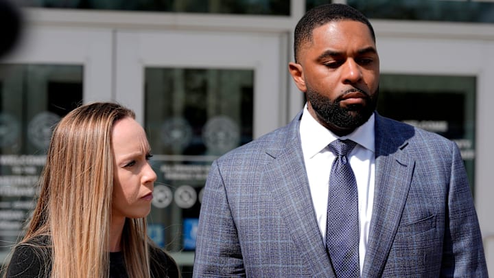 Former University of Michigan football coach Sherrone Moore and his wife Kelli Moore listen to his lawyer, Ellen Michaels, talk to the media after his suspended sentence ruling in the courtroom of Judge J. Cedric Simpson at 14A-1 District Court in Ann Arbor on Tuesday, April, 14, 2026.