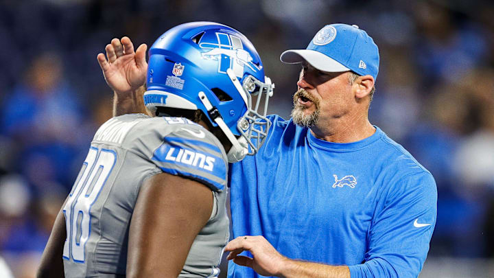 Lions coach Dan Campbell talks to defensive tackle Brodric Martin during warmups before the game against the Raiders 