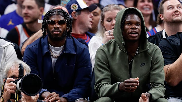 Oct 24, 2023; Denver, Colorado, USA; University of Colorado Buffaloes football players Shedeur Sanders (L) and Travis Hunter (R) watch during the third period between the Denver Nuggets and the Los Angeles Lakers at Ball Arena. 