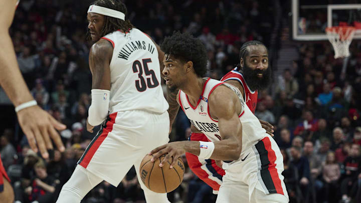 Jan 16, 2025; Portland, Oregon, USA; Portland Trail Blazers guard Scoot Henderson (00) dribbles around center Robert Williams III (35) during the second half against LA Clippers guard James Harden (1) at Moda Center. Mandatory Credit: Troy Wayrynen-Imagn Images
