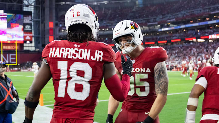 Jan 5, 2025; Glendale, Arizona, USA; Arizona Cardinals wide receiver Marvin Harrison Jr. (18) celebrates a touchdown with tight end Trey McBride (85) against the San Francisco 49ers in the second half at State Farm Stadium. Mandatory Credit: Mark J. Rebilas-Imagn Images