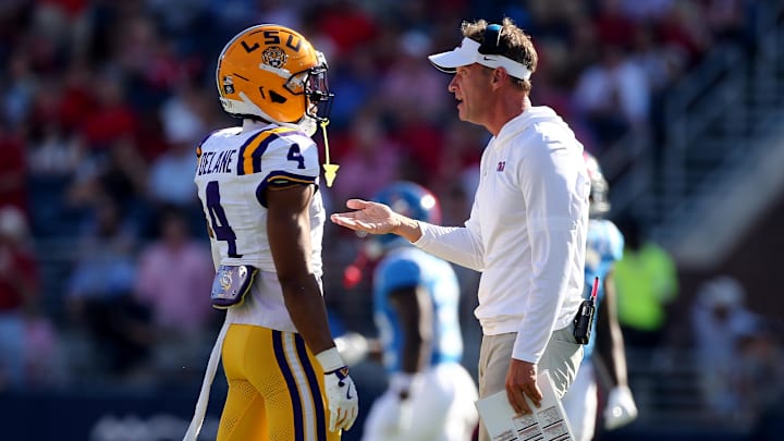 Sep 27, 2025; Oxford, Mississippi, USA; Mississippi Rebels head coach Lane Kiffin talks with LSU Tigers cornerback Mansoor Delane (4) during the second quarter at Vaught-Hemingway Stadium. Mandatory Credit: Petre Thomas-Imagn Images