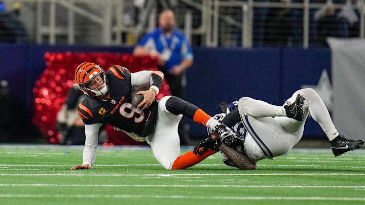 Cincinnati Bengals quarterback Joe Burrow (9) is taken down by Dallas Cowboys linebacker Marist Liufau (35) in the 4th quarter during Monday Night Football at AT&T Stadium in Arlington,Texas on Monday, December 9, 2024. The Bengals won 27-20.