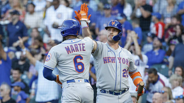 Jul 14, 2022; Chicago, Illinois, USA; New York Mets right fielder Starling Marte (6) celebrates with first baseman Pete Alonso (20) after scoring against the Chicago Cubs during the first inning at Wrigley Field. Mandatory Credit: Kamil Krzaczynski-Imagn Images