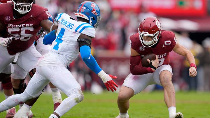 Oklahoma Sooners quarterback John Mateer tries to get away from Ole Miss Rebels linebacker Suntarine Perkins during a matchup. Oklahoma Sooners quarterback John Mateer tries to get away from Ole Miss Rebels linebacker Suntarine Perkins during a matchup.