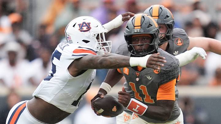 Tennessee quarterback Faizon Brandon (11) carries the ball as Auburn edge Da'Shawn Womack (15) during a college football game on Oct. 3, 2026, in Knoxville, Tennessee. Tennessee quarterback Faizon Brandon (11) carries the ball as Auburn edge Da'Shawn Womack (15) during a college football game on Oct. 3, 2026, in Knoxville, Tennessee.