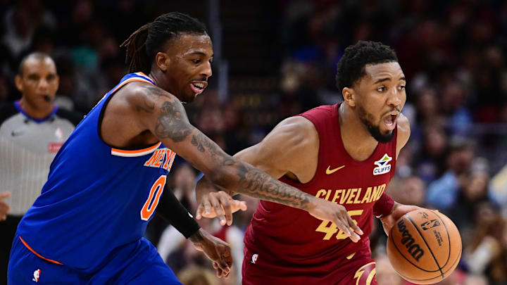 Apr 2, 2025; Cleveland, Ohio, USA; Cleveland Cavaliers guard Donovan Mitchell (45) drives to the basket against New York Knicks guard Delon Wright (0) during the second half at Rocket Arena. Mandatory Credit: Ken Blaze-Imagn Images