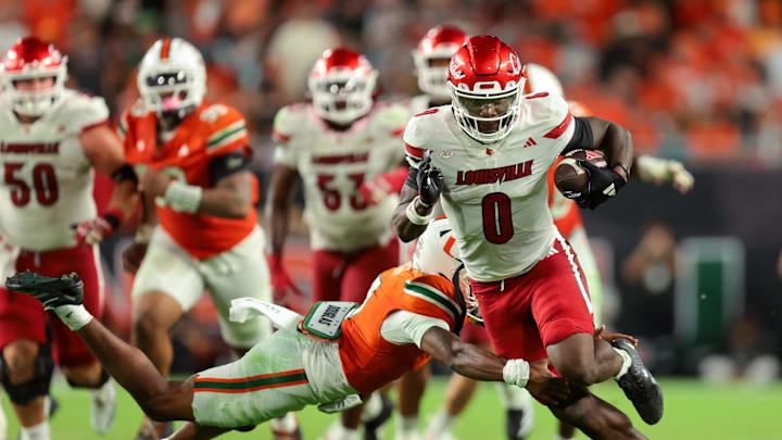 Oct 17, 2025; Miami Gardens, Florida, USA; Louisville Cardinals wide receiver Chris Bell (0) carries the football for a touchdown against the Miami Hurricanes during the fourth quarter at Hard Rock Stadium. Mandatory Credit: Sam Navarro-Imagn Images