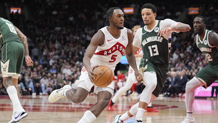 Nov 4, 2025; Toronto, Ontario, CAN; Toronto Raptors guard Immanuel Quickley (5) drives to the net against Milwaukee Bucks guard Ryan Rollins (13) during the second half at Scotiabank Arena. Mandatory Credit: John E. Sokolowski-Imagn Images