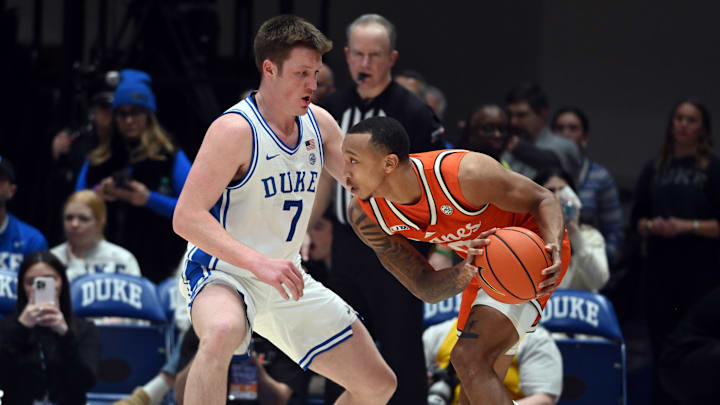 Jan 14, 2025; Durham, North Carolina, USA; Miami Hurricanes guard Matthew Cleveland (0) controls the ball in front of Duke Blue Devils forward Kon Knueppel (7) during the second half at Cameron Indoor Stadium. Mandatory Credit: Rob Kinnan-Imagn Images
