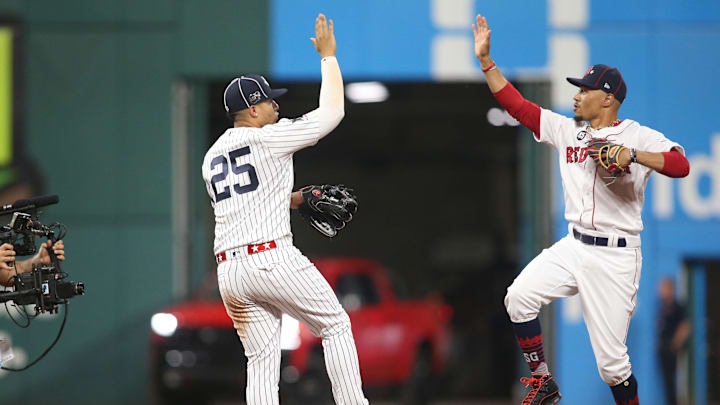 Jul 9, 2019; Cleveland, OH, USA;  American League second baseman Gleyber Torres (25) of the New York Yankees and center fielder Mookie Betts (50) of the Boston Red Sox celebrate after defeating the National League in the 2019 MLB All Star Game at Progressive Field.