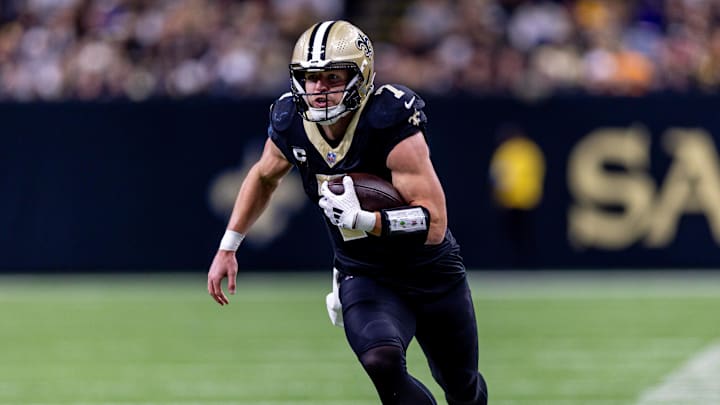 Dec 1, 2024; New Orleans, Louisiana, USA;  New Orleans Saints tight end Taysom Hill (7) rushes against the Los Angeles Rams during the first half at Caesars Superdome. Mandatory Credit: Stephen Lew-Imagn Images