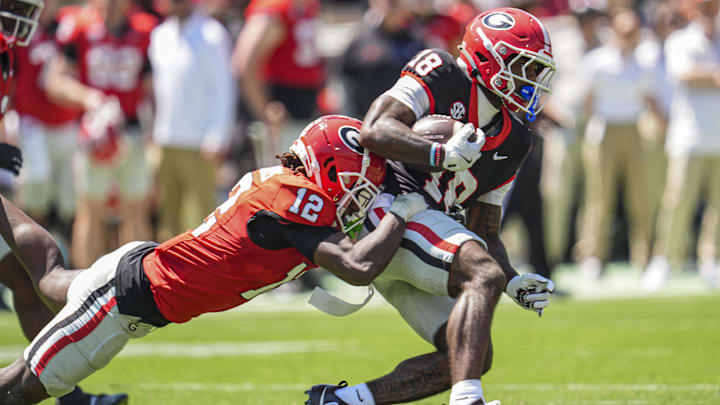 Apr 12, 2025; Athens, GA, USA; Georgia Bulldogs wide receiver Sacovie White (18) is tackled by defensive back Jaden Harris (12) during the Georgia Spring game at Sanford Stadium. Mandatory Credit: Dale Zanine-Imagn Images Apr 12, 2025; Athens, GA, USA; Georgia Bulldogs wide receiver Sacovie White (18) is tackled by defensive back Jaden Harris (12) during the Georgia Spring game at Sanford Stadium. Mandatory Credit: Dale Zanine-Imagn Images