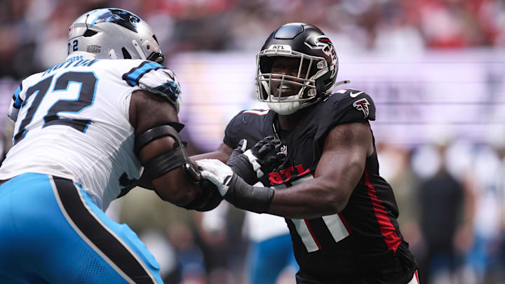 Atlanta Falcons edge Jalon Walker (11) and Carolina Panthers tackle Taylor Moton (72) battle 