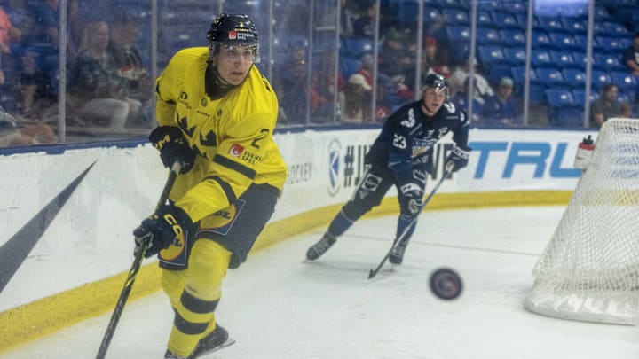 Aug 3, 2024; Plymouth, MI, USA; Sweden's defenseman Kristian Kostadinski (2) clears the puck against Finland during the third period of the 2024 World Junior Summer Showcase at USA Hockey Arena. Mandatory Credit: David Reginek-Imagn Images