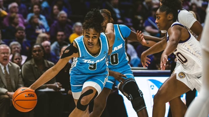 Tulane women's basketball player Kendall Sneed dribble by defender.