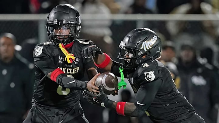 Dallas South Oak Cliff quarterback Jayden Williams, left, hands off to Levon Morton in a playoff game against Terrell. Dallas South Oak Cliff quarterback Jayden Williams, left, hands off to Levon Morton in a playoff game against Terrell.