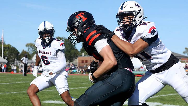 Thayer’s Neil MacKinnon of Duxbury is tackled by Lawrence Academy’s Isaiah Green of Hull during third quarter action of their game against Lawrence Academy at Thayer Academy on Saturday, Sept. 20, 2025. Thayer would go on to lose 28-6.