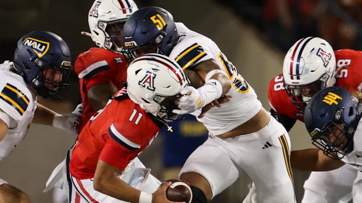 Sep 7, 2024; Tucson, Arizona, USA; Northern Arizona Lumberjacks defensive lineman Micah Carreon (51) grabs the mask of Arizona Wildcats quarterback Noah Fifita (11) during third quarter at Arizona Stadium. Sep 7, 2024; Tucson, Arizona, USA; Northern Arizona Lumberjacks defensive lineman Micah Carreon (51) grabs the mask of Arizona Wildcats quarterback Noah Fifita (11) during third quarter at Arizona Stadium.
