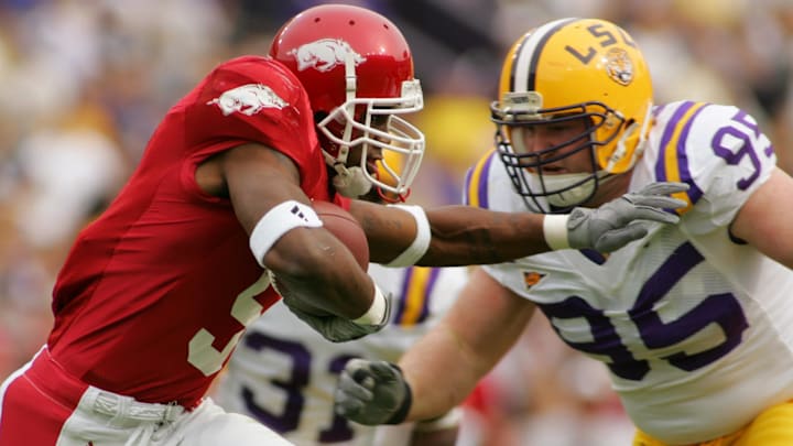 Nov. 25, 2005; Baton Rouge, LA, USA; Arkansas Razorbacks Darren McFadden (5) on a carry against Louisiana State Tigers Kyle Williams (95) in the first half of action Friday Nov. 25, 2005 at Tiger Stadium. Mandatory Credit: John David Mercer-Imagn Images © 2005 John David Mercer Nov. 25, 2005; Baton Rouge, LA, USA; Arkansas Razorbacks Darren McFadden (5) on a carry against Louisiana State Tigers Kyle Williams (95) in the first half of action Friday Nov. 25, 2005 at Tiger Stadium. Mandatory Credit: John David Mercer-Imagn Images © 2005 John David Mercer
