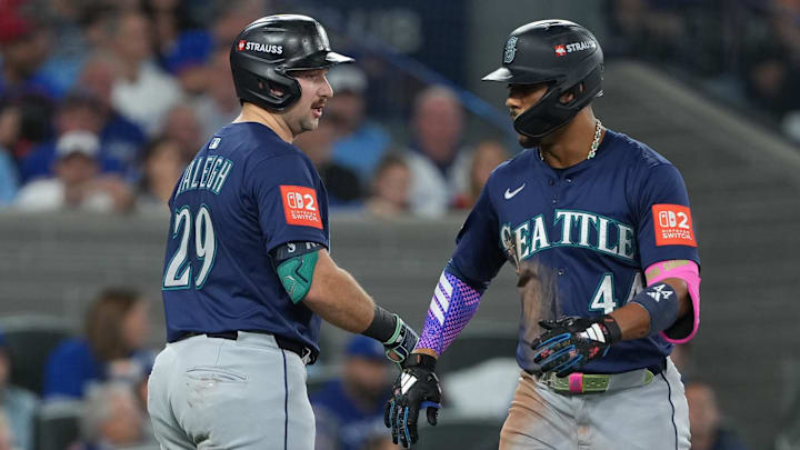 Oct 20, 2025; Toronto, Ontario, CAN; Seattle Mariners center fielder Julio Rodriguez (44) celebrates with catcher Cal Raleigh (29) after hitting a home run in the third inning against the Toronto Blue Jays during game seven of the ALCS round for the 2025 MLB playoffs at Rogers Centre. Mandatory Credit: Nick Turchiaro-Imagn Images
