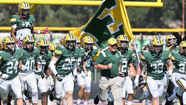 St. Edward head coach Tom Lombardo leads the team onto the field for a game against River rouge (Michigan) on September 23, 2024.