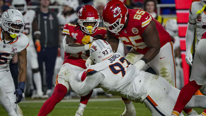 Dec 25, 2025; Kansas City, Missouri, USA; Kansas City Chiefs running back Isiah Pacheco (10) runs the ball as Denver Broncos defensive tackle D.J. Jones (93) tackles during the second quarter at GEHA Field at Arrowhead Stadium. 