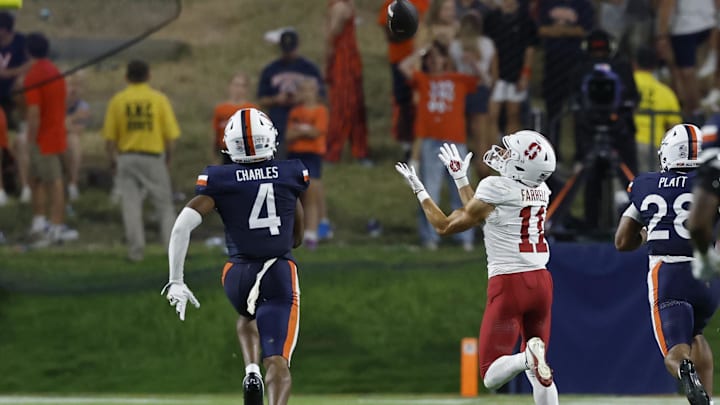 Sep 20, 2025; Charlottesville, Virginia, USA; Stanford Cardinal wide receiver Bryce Farrell (11) catches a touchdown pass as Virginia Cavaliers defensive back Christian Charles (4) and Cavaliers defensive back Donavon Platt (28) chase during the third quarter at Scott Stadium. Mandatory Credit: Geoff Burke-Imagn Images Sep 20, 2025; Charlottesville, Virginia, USA; Stanford Cardinal wide receiver Bryce Farrell (11) catches a touchdown pass as Virginia Cavaliers defensive back Christian Charles (4) and Cavaliers defensive back Donavon Platt (28) chase during the third quarter at Scott Stadium. Mandatory Credit: Geoff Burke-Imagn Images