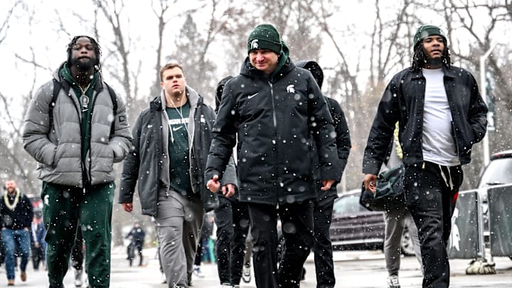 Michigan State's head coach Jonathan Smith, center, and the football team enter Spartan Stadium before the game against Rutgers on Saturday, Nov. 30, 2024, in East Lansing.