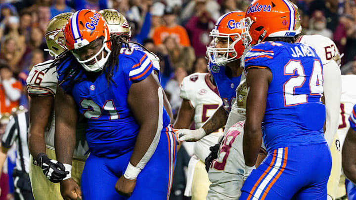Florida Gators defensive lineman Desmond Watson (21) celebrates his sack of Florida State Seminoles quarterback Tate Rodemaker (18) at Steve Spurrier Field at Ben Hill Griffin Stadium in Gainesville, FL on Saturday, November 25, 2023 during the second half. Florida State won 24-15. [Doug Engle/Gainesville Sun]