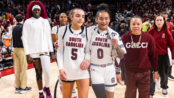 Jan 24, 2025; Columbia, South Carolina, USA; South Carolina Gamecocks guard Tessa Johnson (5), guard Te-Hina Paopao (0), and head coach Dawn Staley celebrate their win over the LSU Lady Tigers at Colonial Life Arena. Mandatory Credit: Jeff Blake-Imagn Images