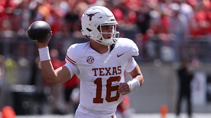 Texas Longhorns quarterback Arch Manning drops back to pass against the Ohio State Buckeyes. Texas Longhorns quarterback Arch Manning drops back to pass against the Ohio State Buckeyes.