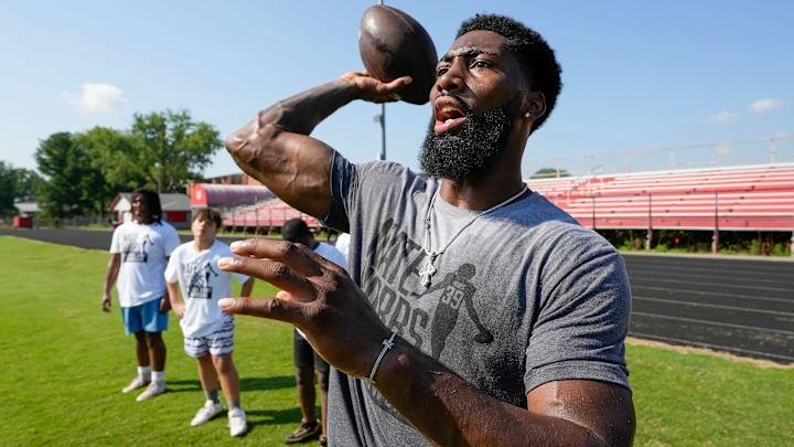 Nate Hobbs works with aspiring young football players at the camp that bears his name. The camp was held at Waggener High School on Saturday, July 13, 2024.