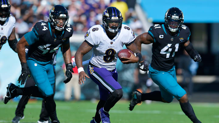 Jacksonville Jaguars linebacker Travon Walker (44) and linebacker Josh Allen (41) try to run down