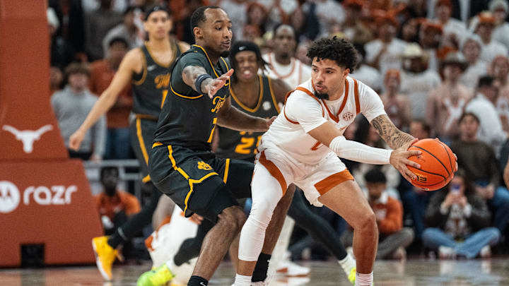 Texas Longhorns guard Jordan Pope (0) protects the ball from Missouri Tigers center Trent Burns (7) as the Longhorns take on Mizzou at the Moody Center on Jan. 21, 2025. Texas Longhorns guard Jordan Pope (0) protects the ball from Missouri Tigers center Trent Burns (7) as the Longhorns take on Mizzou at the Moody Center on Jan. 21, 2025.
