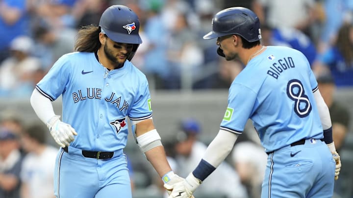 May 22, 2024; Toronto, Ontario, CAN; Toronto Blue Jays right fielder Cavan Biggio (8) congratulates shortstop Bo Bichette (11) after his two-run home run against the Chicago White Sox during the second inning at Rogers Centre